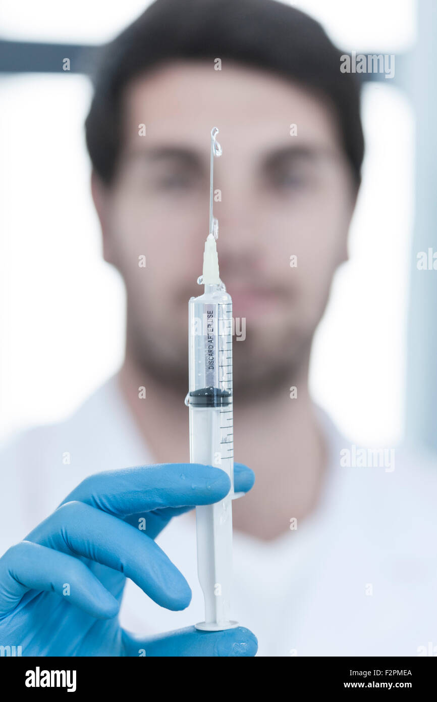 Doctor holding syringe with liquid Stock Photo Alamy