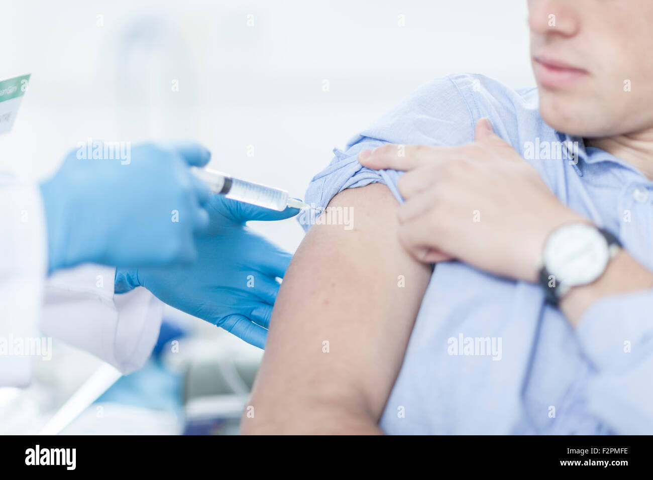 Doctor giving patient injection Stock Photo