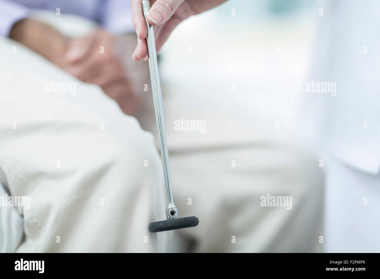 Doctor and patient with reflex hammer Stock Photo