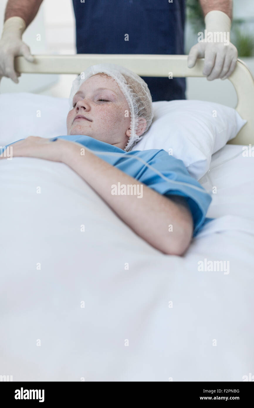 Girl in hospital bed with closed eyes Stock Photo