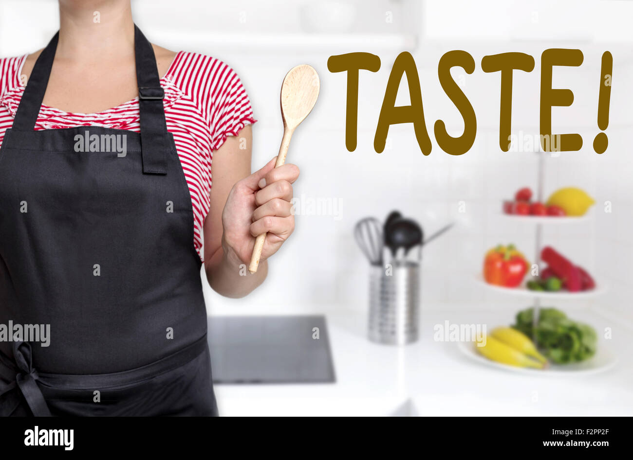 taste cook holding wooden spoon background concept. Stock Photo