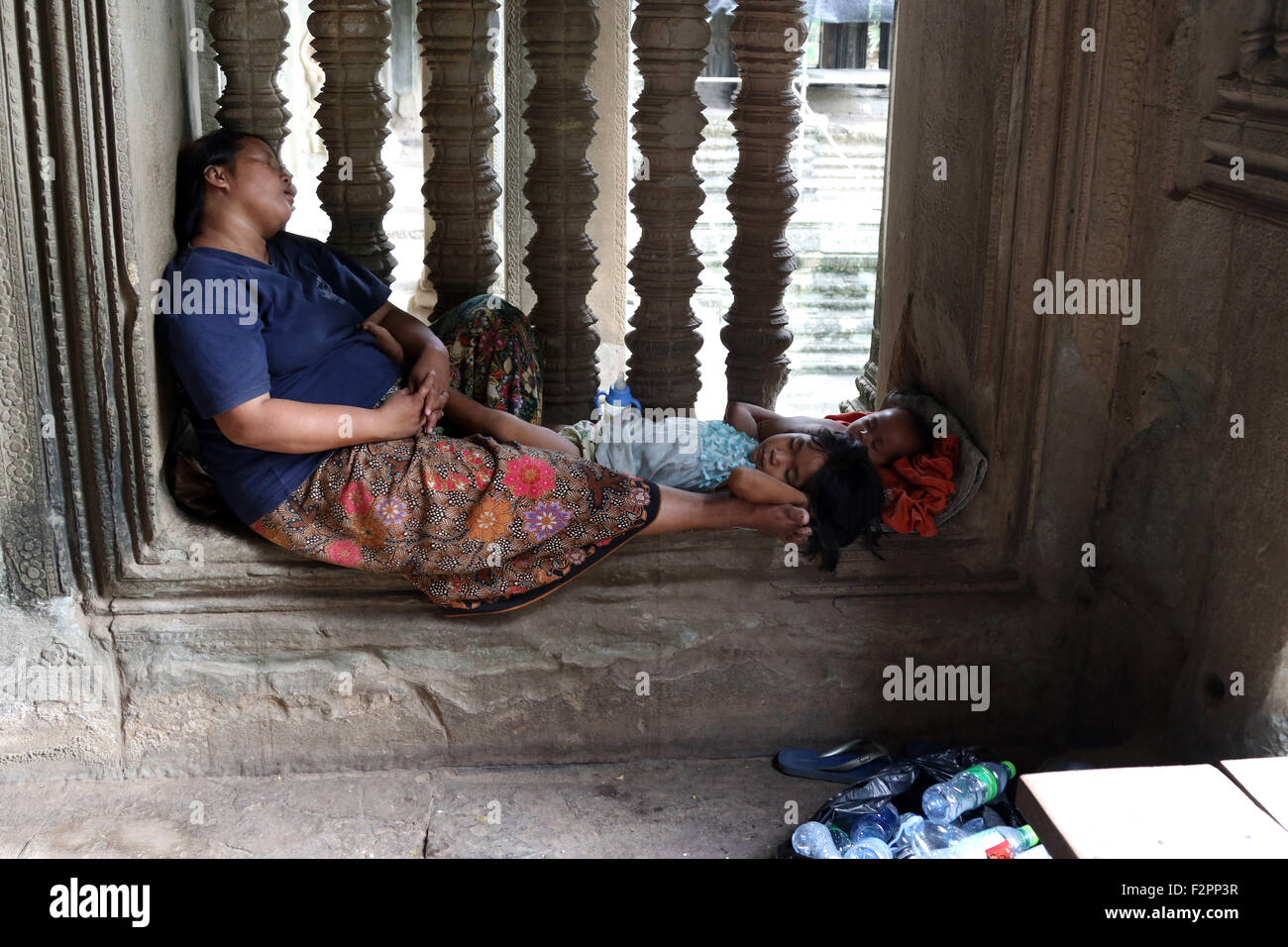 Woman child mum kids asleep Angkor Wat inside Stock Photo