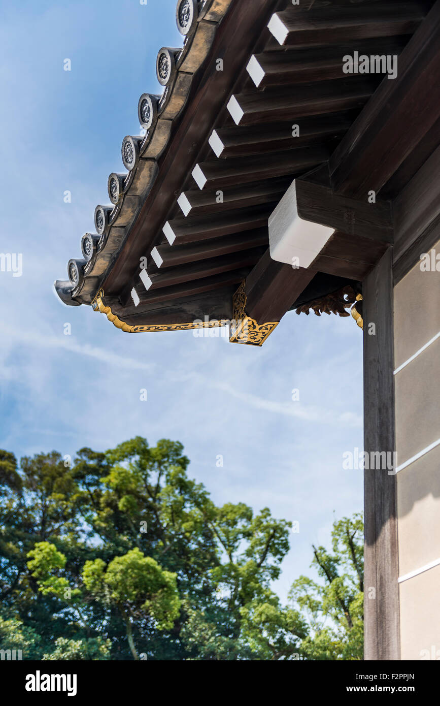 Traditional Japanese ornate wooden roof overhang with gold decoration Stock Photo
