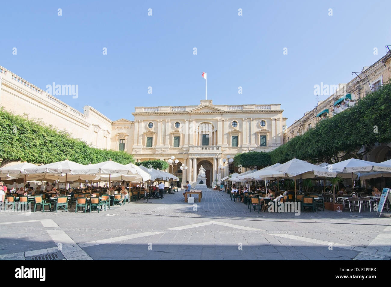 Caffe Cordina outdoor restaurant and cafe and the National Library classical baroque building on a sunny day in September Stock Photo