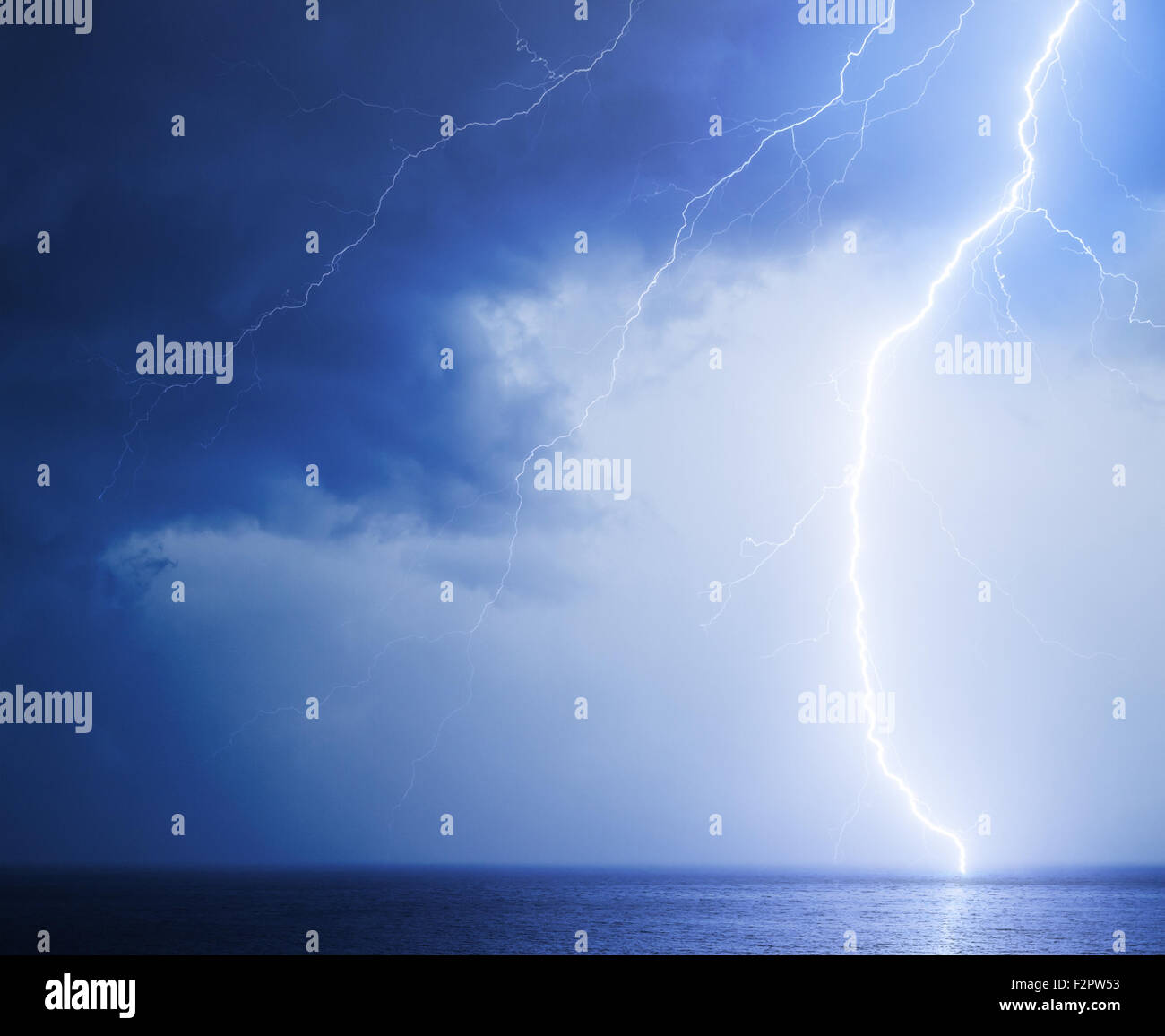 Seascape with bright lightning in dark blue sky Stock Photo