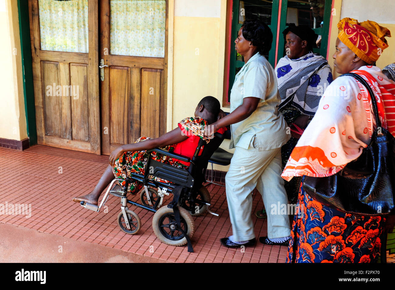 TANZANIA, Korogwe, village Kwalukonge, KWALUKONGE HEALTH CENTRE, patient in wheel chair on the way to operation theatre Stock Photo
