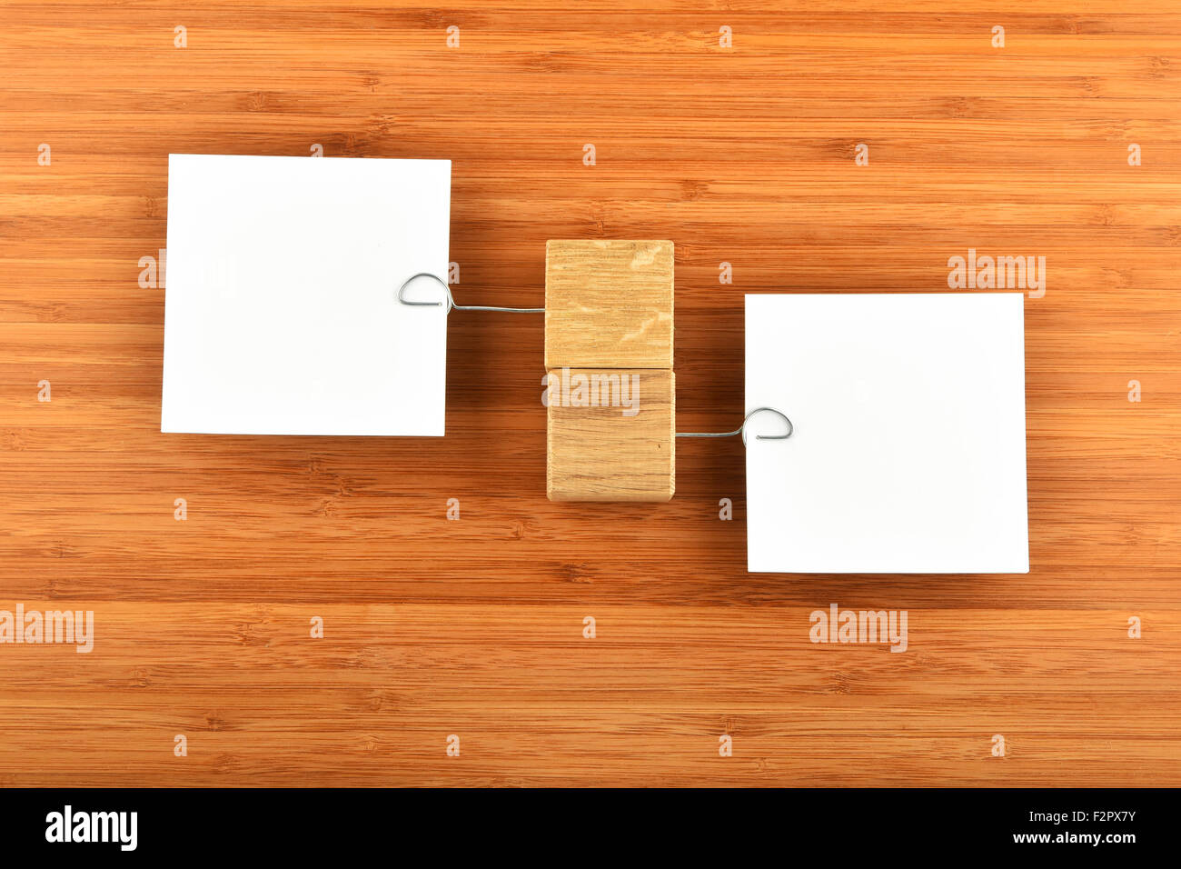 Opposite Opinion, Two white paper notes with wooden holders in ...