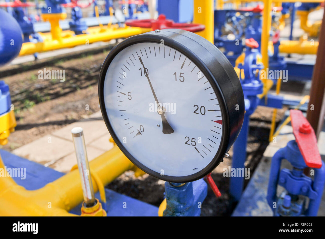 Pressure Meter And Red Faucet With Steel Yellow Pipe In Natural