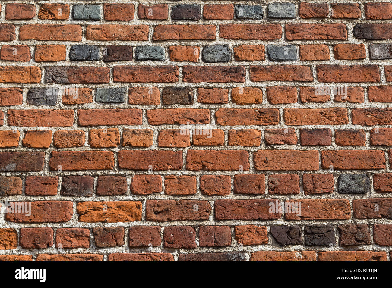 Photograph of a red brick wall in horizontal pattern. Stock Photo