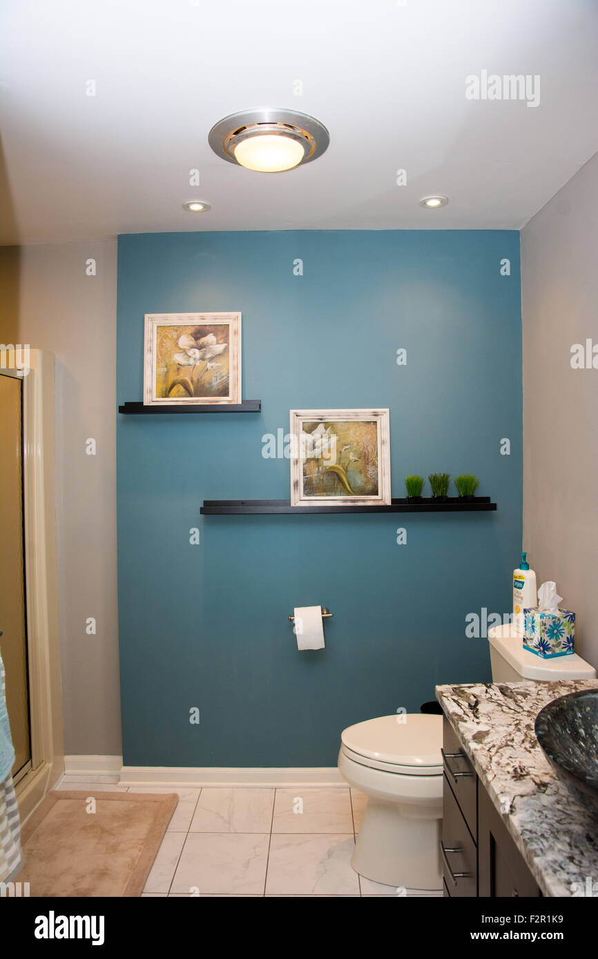 A nicely appointed bathroom with a teal blue wall Stock Photo
