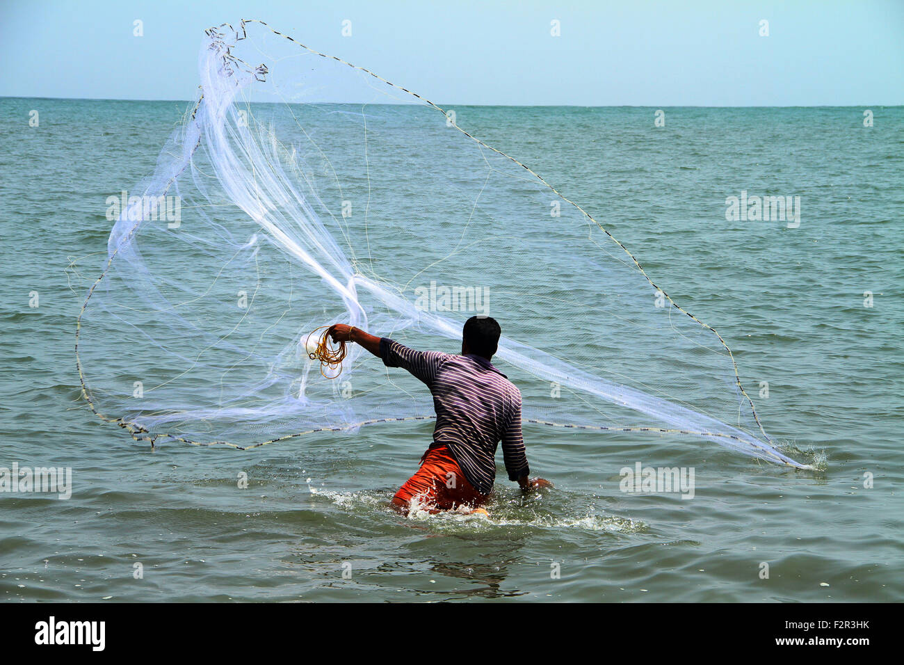 fisherman throwing fish net Stock Photo Alamy