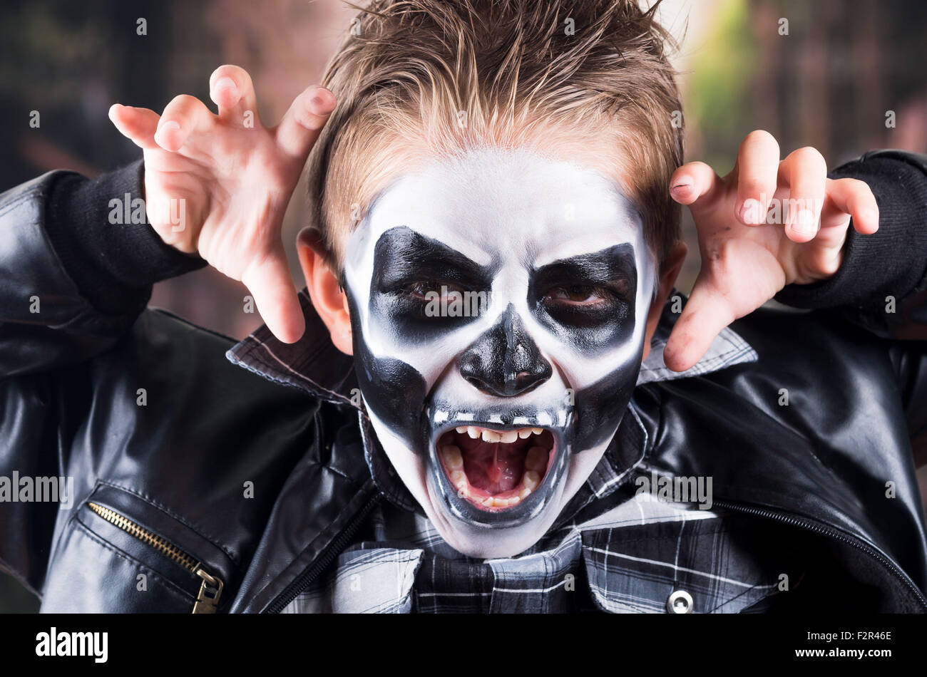 Scary little boy wearing skull makeup Stock Photo