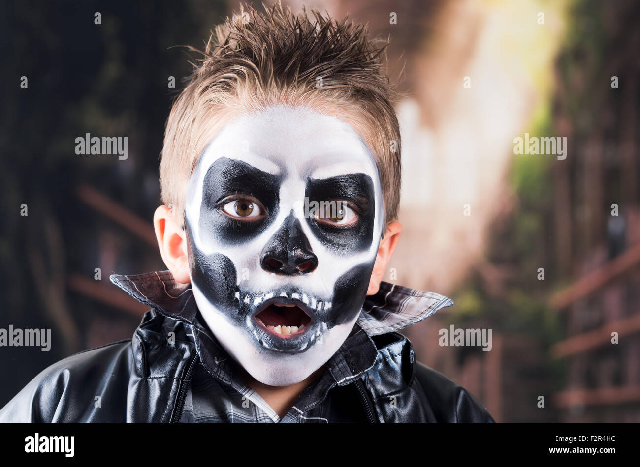 Scary little boy wearing skull makeup Stock Photo Alamy