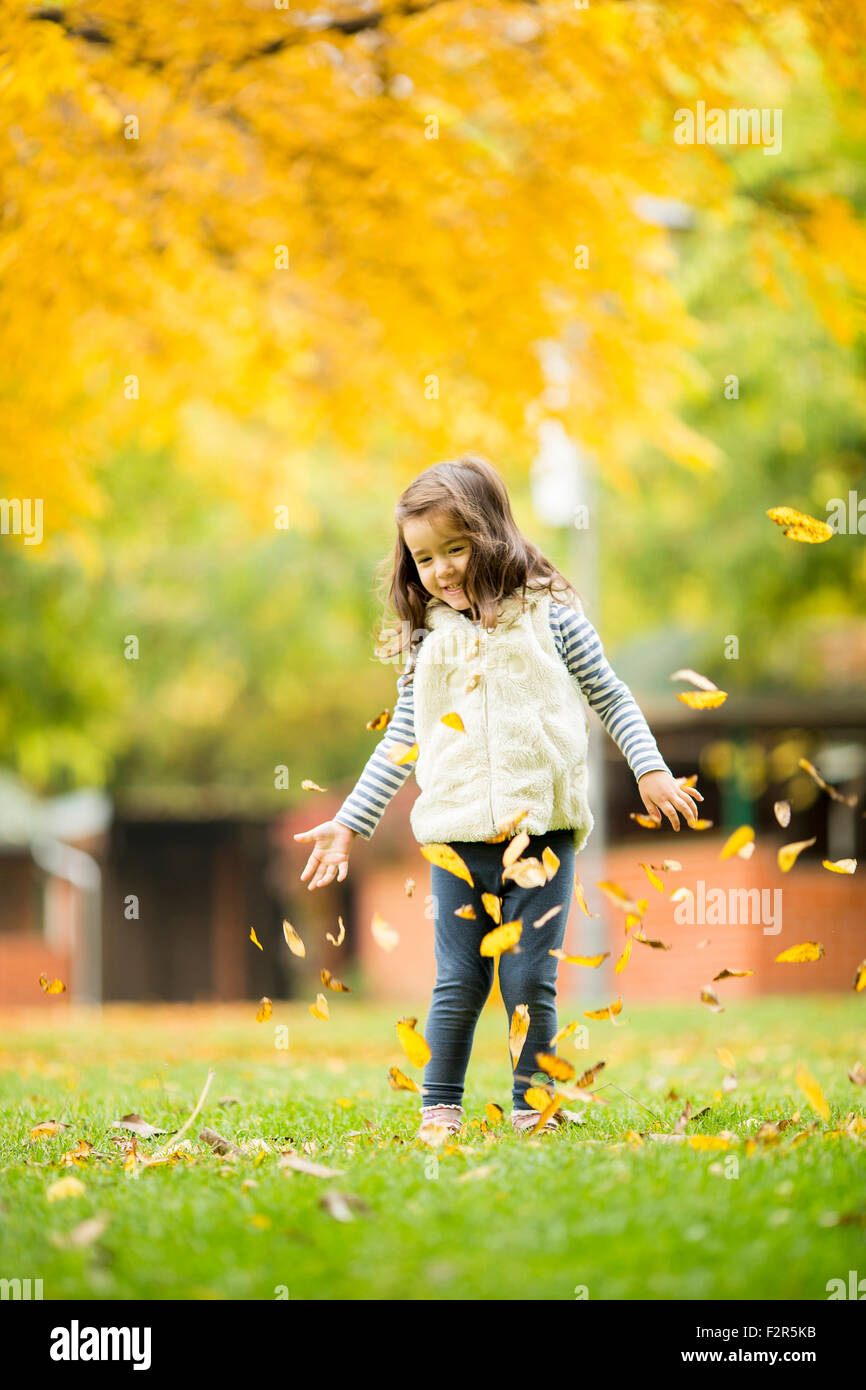 Little girl at the autumn park Stock Photo - Alamy
