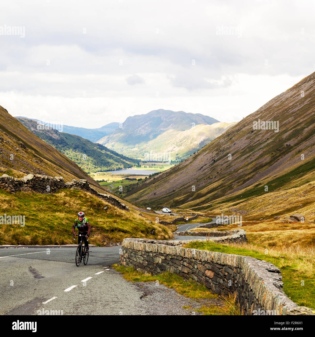 Cycling Kirkstone Pass with an altitude of 1,489 feet is the Lake District’s highest  that is open to motor traffic Cumbria UK Stock Photo
