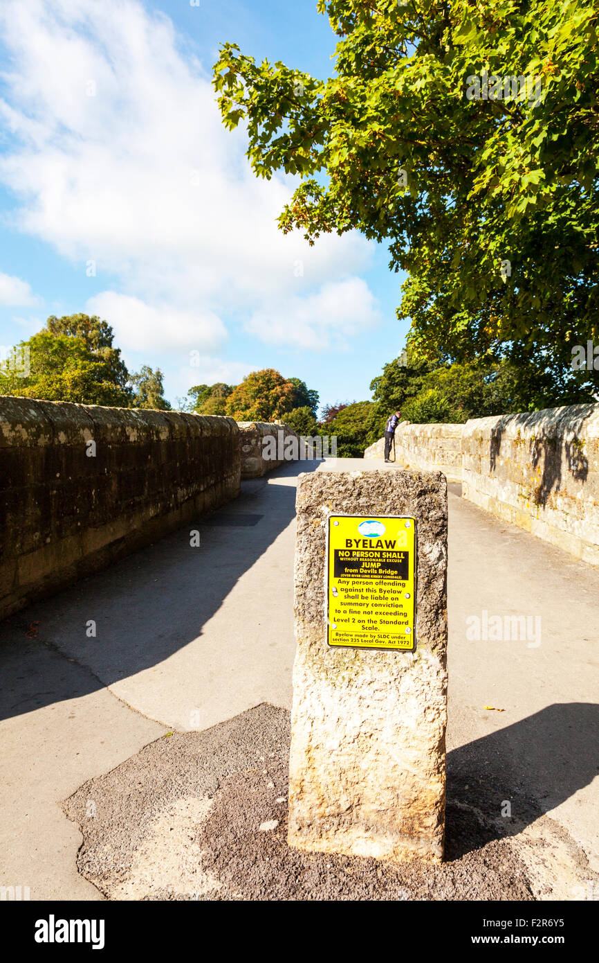 devil's bridge kirkby lonsdale do not jump off sign man looking over ...