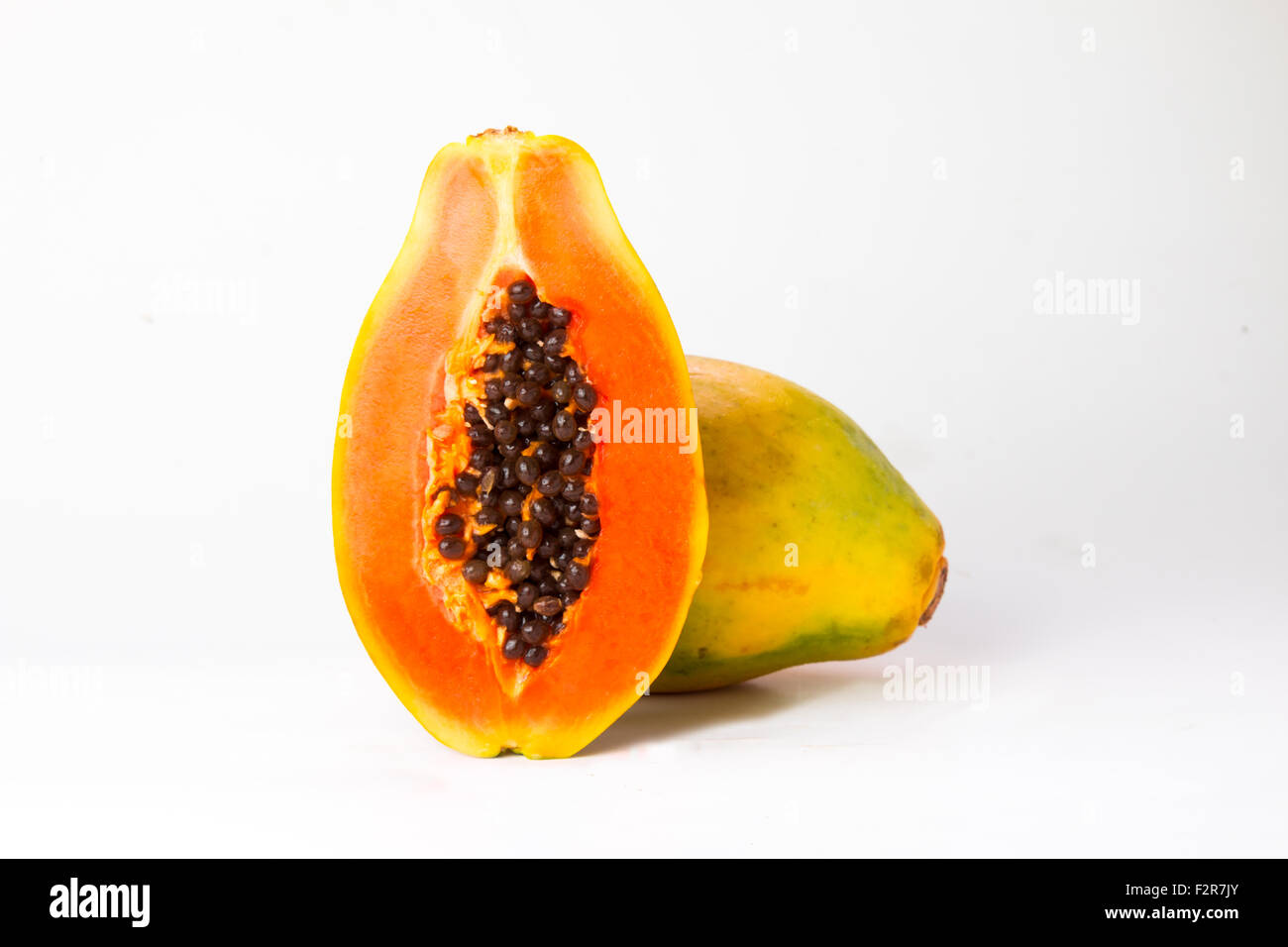 papaya with a slice isolated on white background Stock Photo