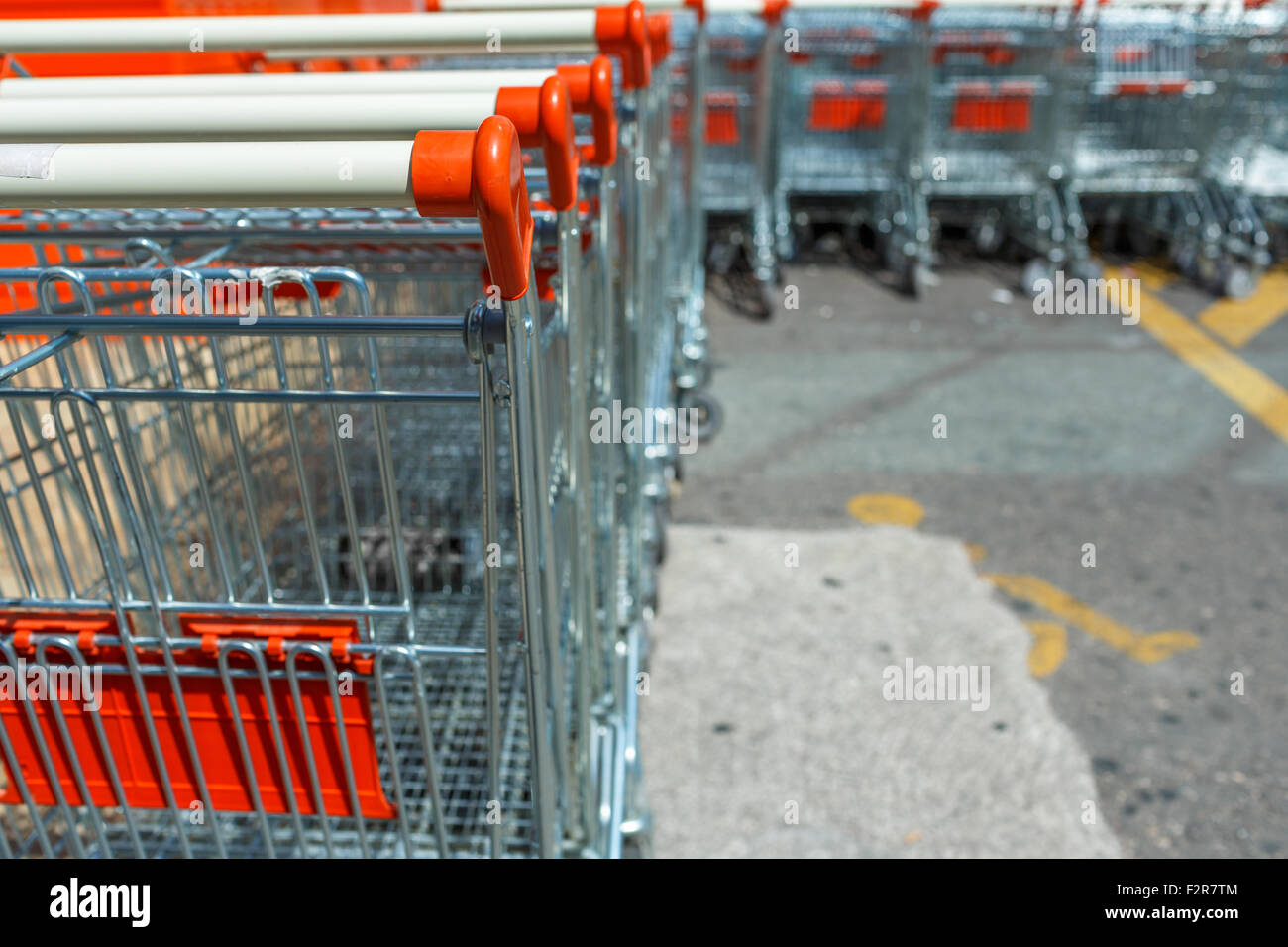 A lot of shopping carts at the parking near the supermarket Stock Photo