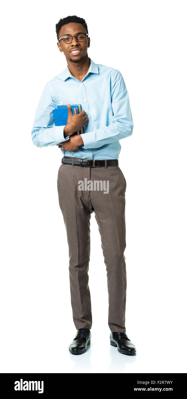 Happy african american college student standing with books in his hands on white background Stock Photo