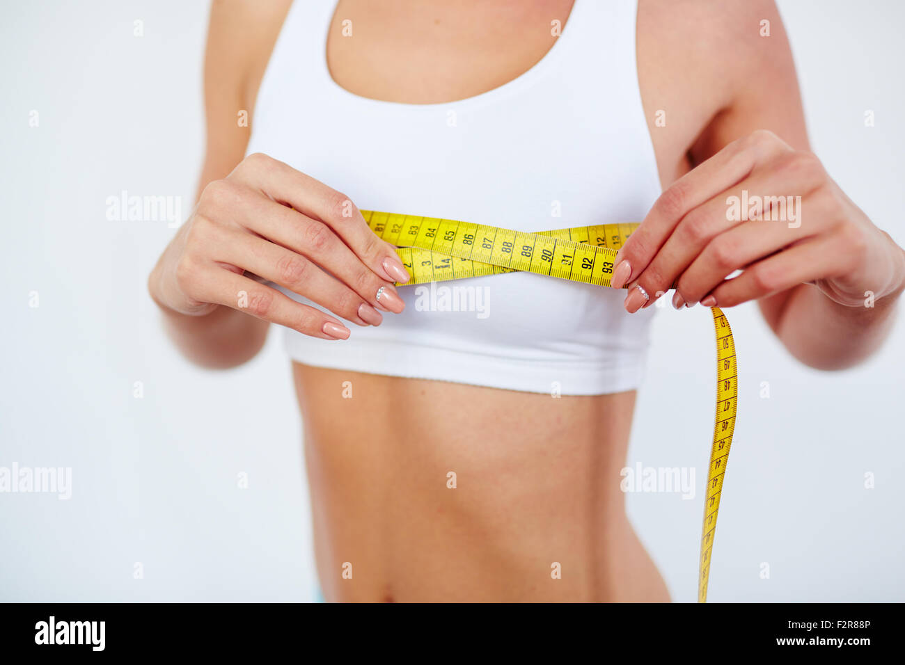 Young female measuring size of chest Stock Photo - Alamy