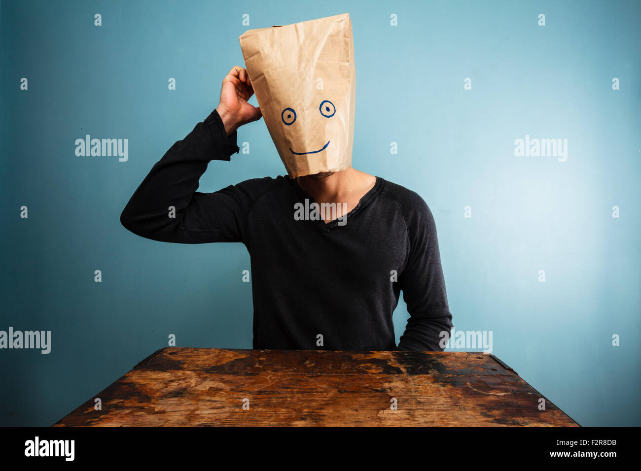 A Man Pull A Paper Bag With Hole Over His Head High-Res Stock Photo - Getty  Images
