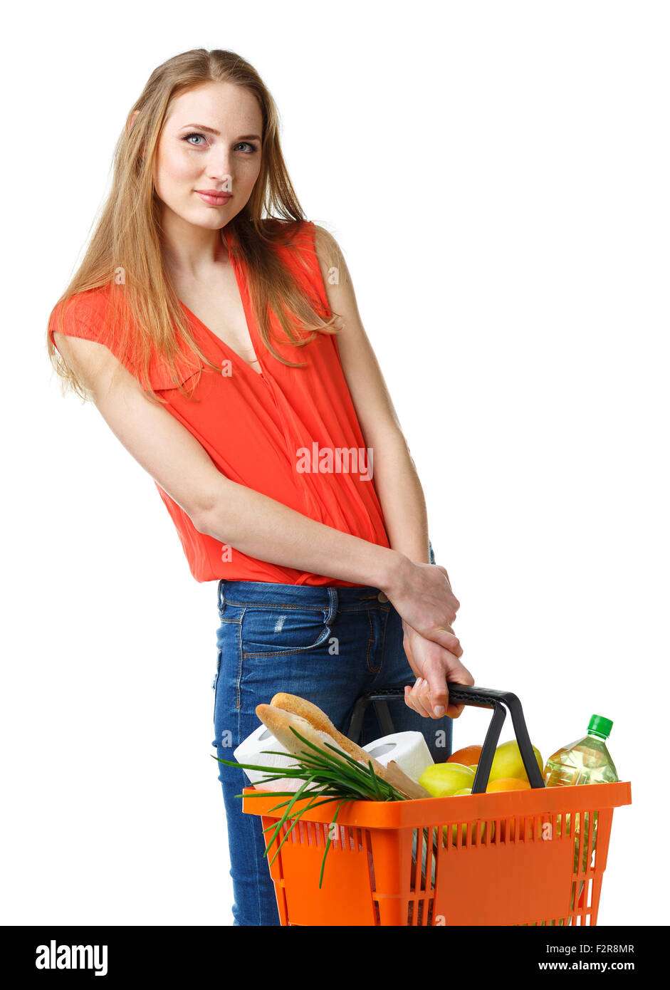 Happy young woman holding a basket full of healthy food on white ...