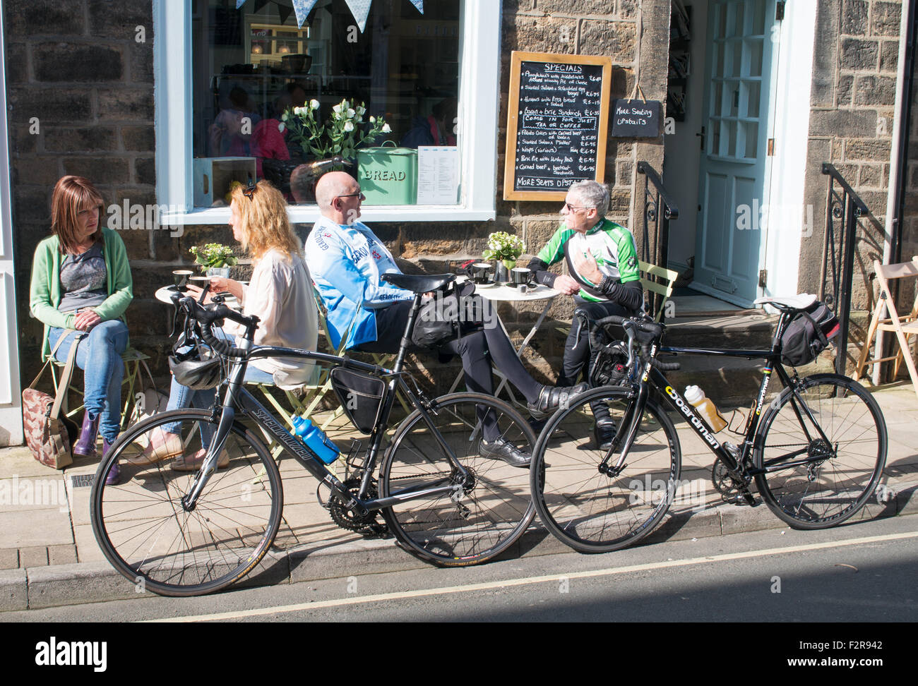 Cyclists sat outside café in Otley, West Yorkshire, England, UKcycl Stock Photo