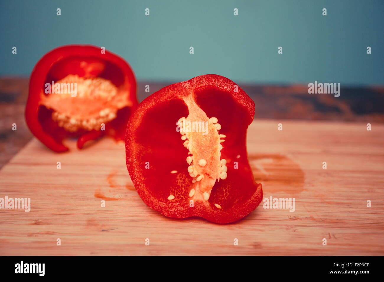 Red bell pepper on chopping board Stock Photo - Alamy