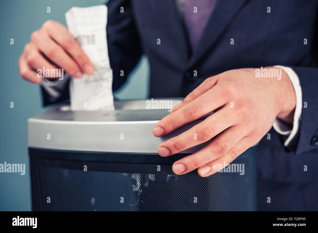 A Businessman is shredding important documents Stock Photo Alamy