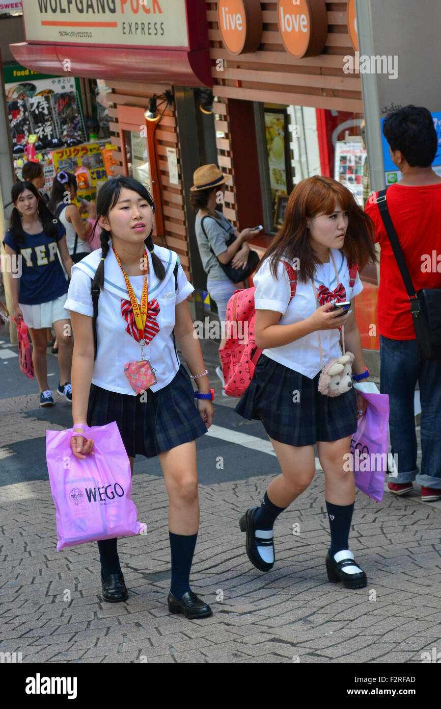 Two schoolgirls walking. Harajuku, Tokyo. Stock Photo