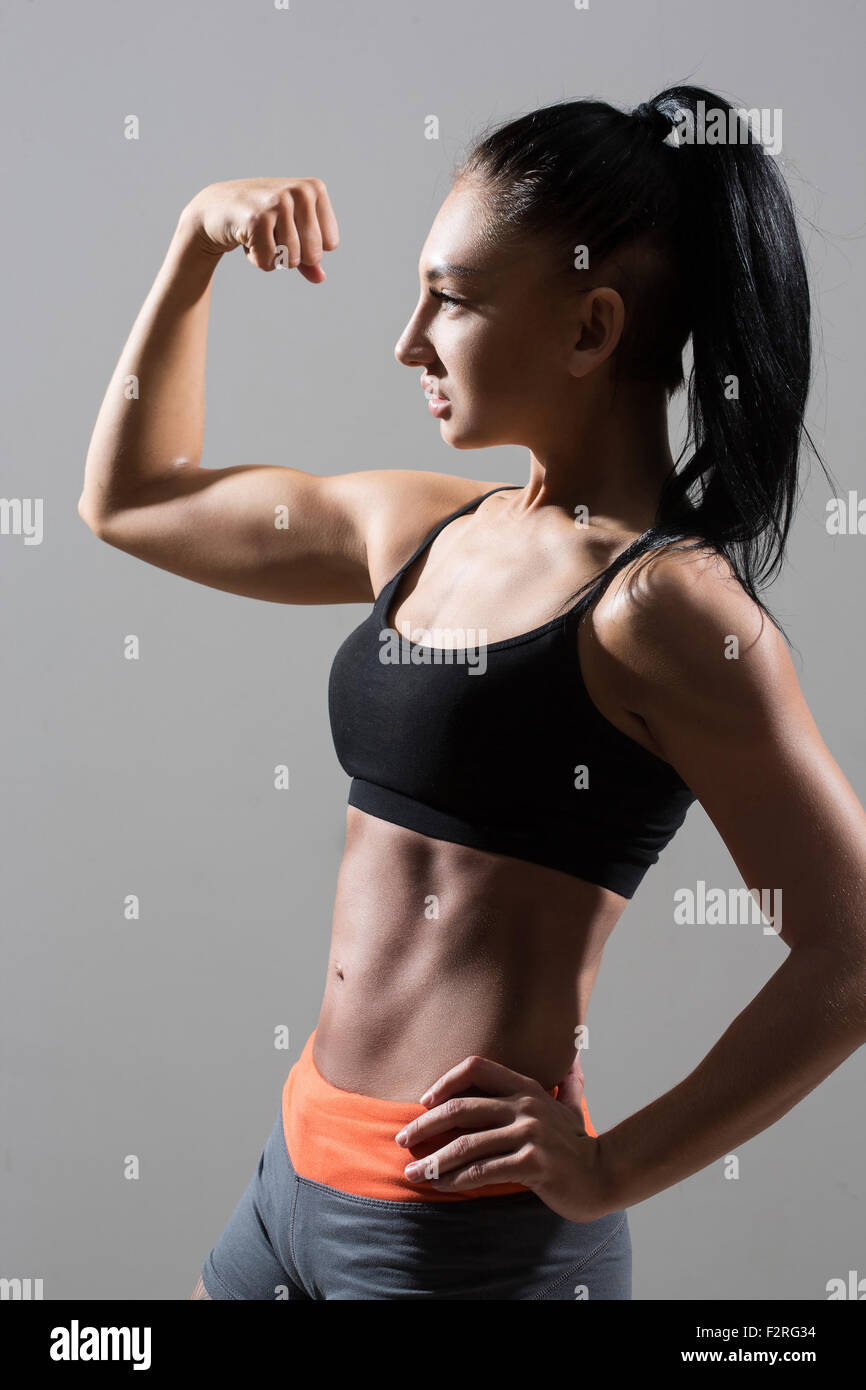 Young woman shows biceps hi-res stock photography and images - Alamy