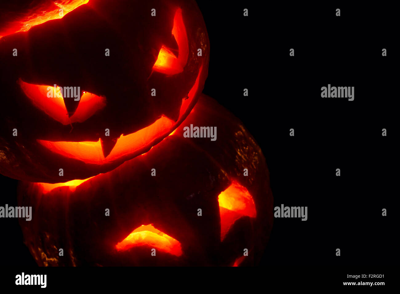 Illuminated cute halloween pumpkins isolated on black background Stock ...