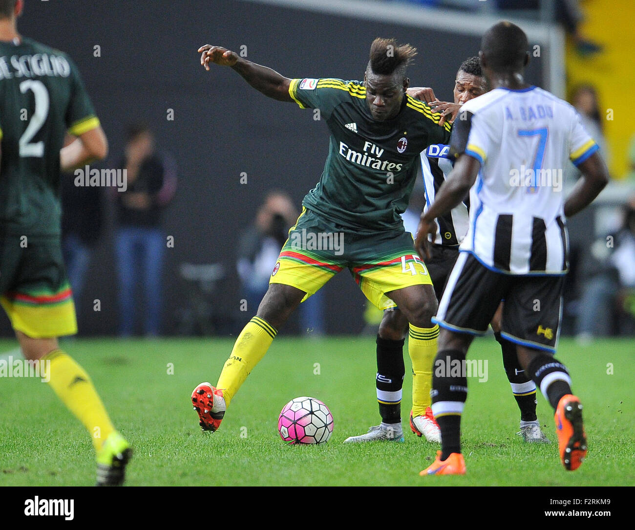 Udine, Italy. 22nd September, 2015. Milan' forward Mario Balotelli (C) fight for the ball with Udinese's defender Andrade Dos Santos Edenilson during the Italian Serie A TIM football match between Udinese Calcio and AC Milan at Friuli Stadium. 22th September 2015. photo Simone Ferraro / Alamy Live News Stock Photo