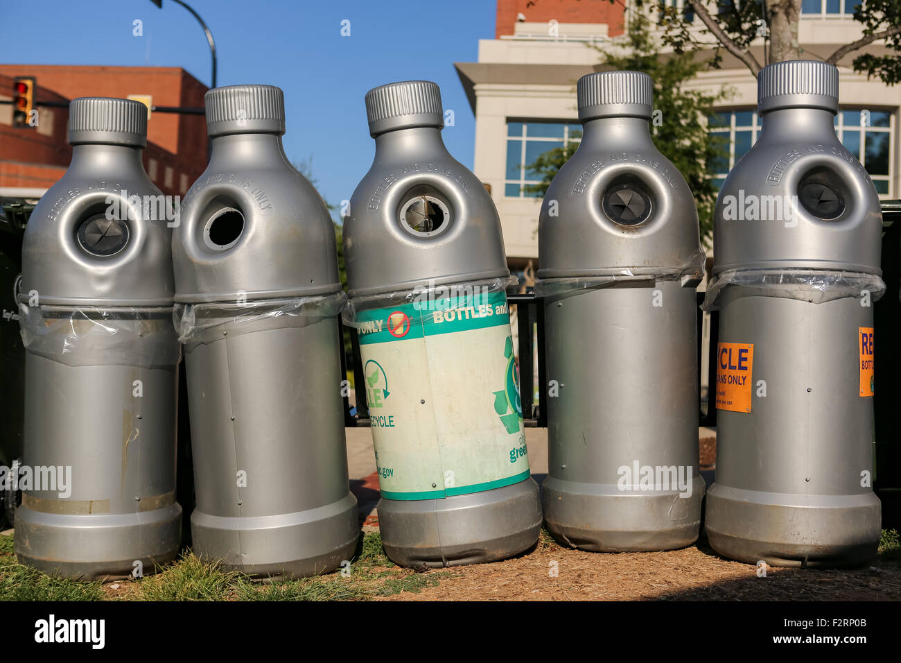 Plastic bottle recycling bins shaped like a bottle along Main Street at