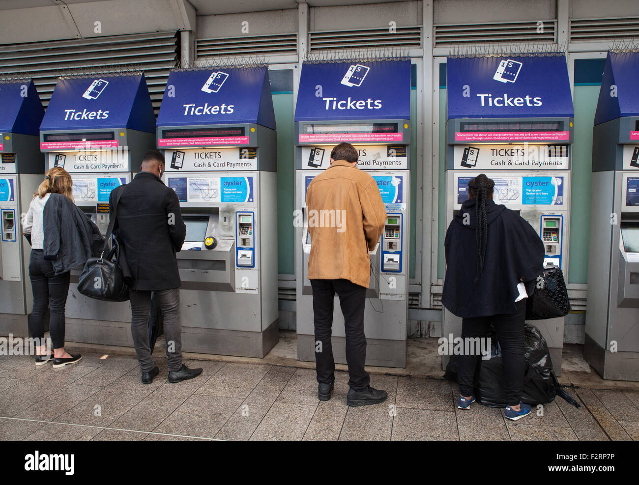 Rail passengers use self-service ticket machines at London Bridge train station Stock Photo