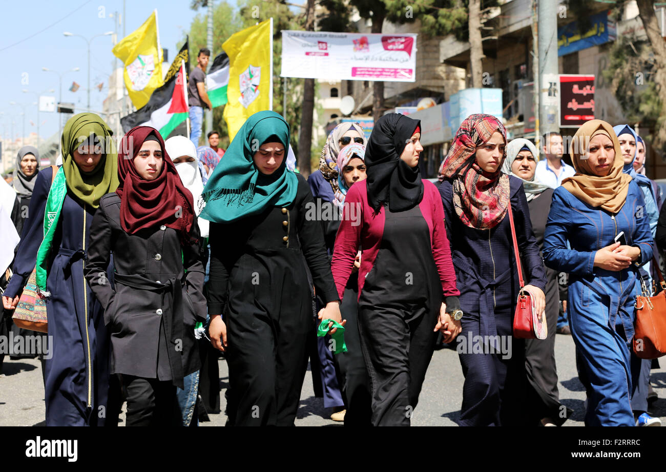 Female mourners partake in the funeral procession of 18-year-old Palestinian Hadeel al-Hashlamon, who was shot and killed by Israeli soldiers. In less than 24 hours, the Israeli army shot and killed two Palestinians. On September 22, 2015, the Israeli army claimed that 21-year-old Diyaa Abdul-Halim Talahmah was killed when a hand-made grenade exploded in his hands during clashes with Israeli forces in the village of Khursa, south of Hebron. However, there were contradictory reports from both Palestinian and Israeli sources and photos of the youth's body showed that he had been shot. That same Stock Photo