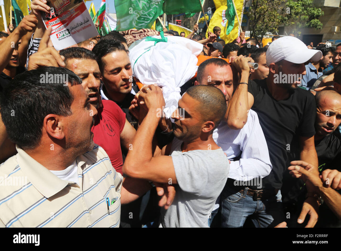 Mourners carry the body of 18-year-old Palestinian Hadeel al-hashlamon, who was shot and killed by Israeli soldiers in the West Bank city of Hebron. In less than 24 hours, the Israeli army shot and killed two Palestinians. On September 22, 2015, the Israeli army claimed that 21-year-old Diyaa Abdul-Halim Talahmah was killed when a hand-made grenade exploded in his hands during clashes with Israeli forces in the village of Khursa, south of Hebron. However, there were contradictory reports from both Palestinian and Israeli sources and photos of the youth's body showed that he had been shot. That Stock Photo