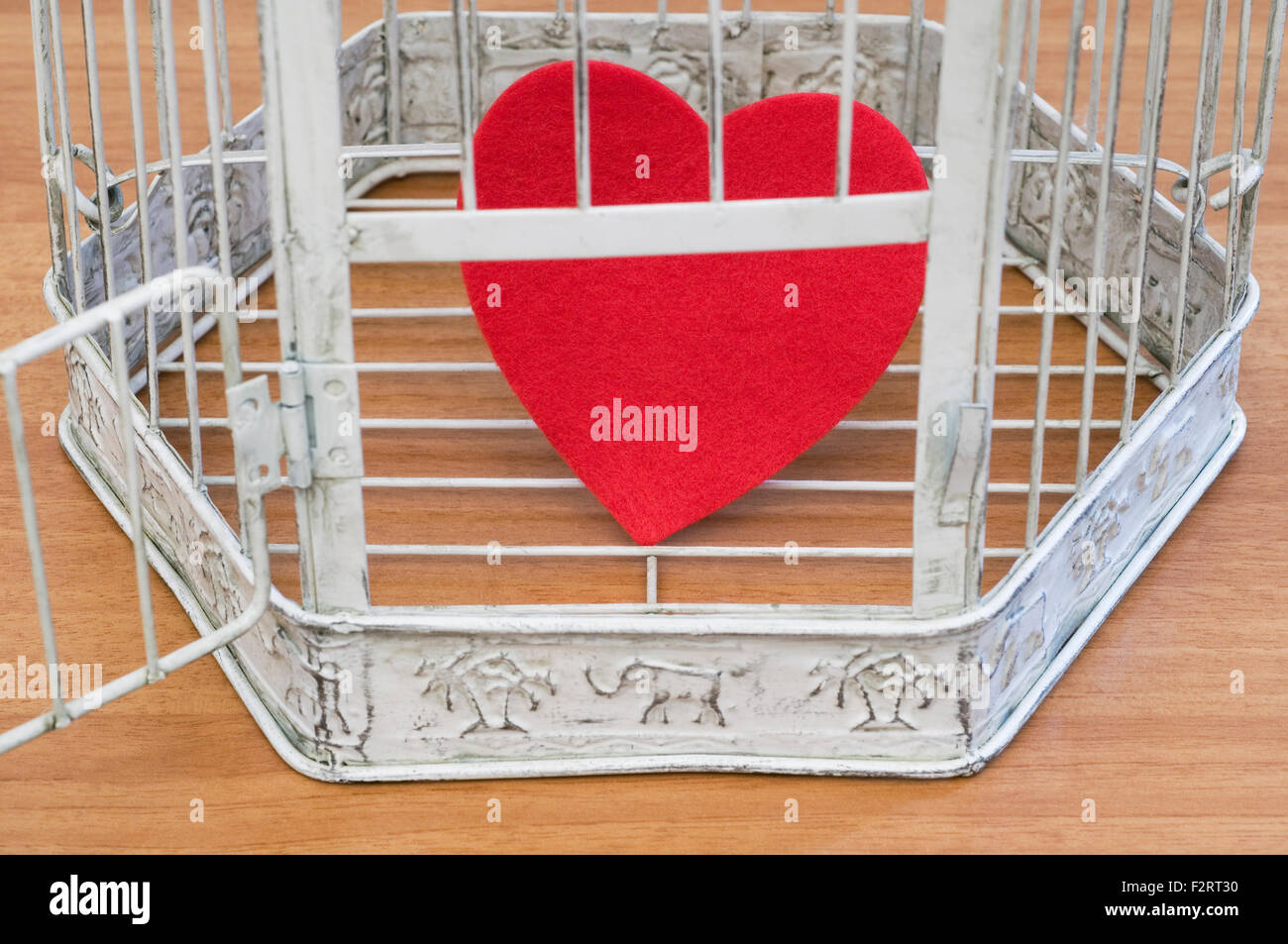heart inside a cage with open door Stock Photo Alamy