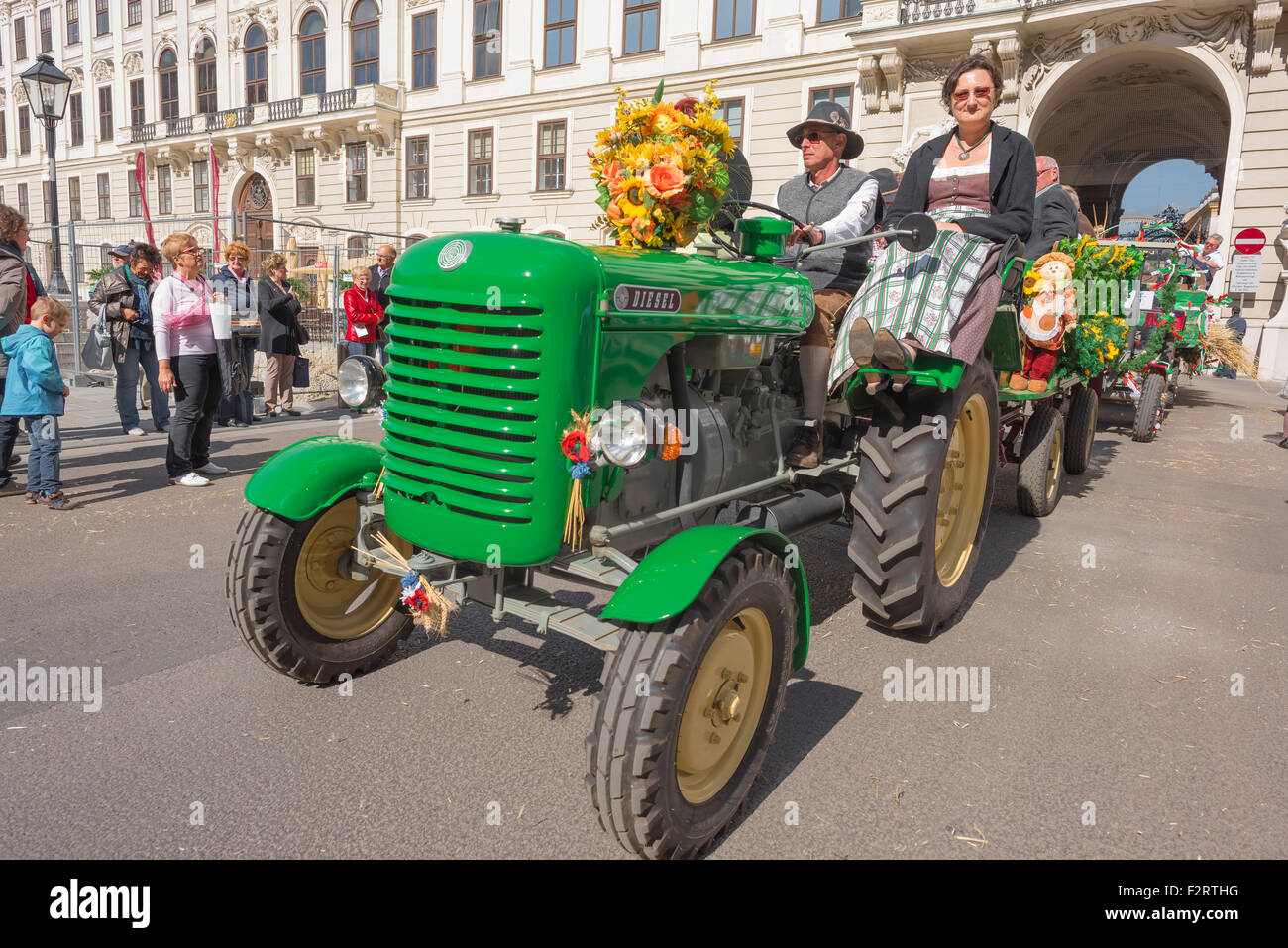 Austria farmer tractor, view of a farmer driving his tractor into the courtyard of the Hofburg Palace at harvest festival time, Wien, Austria. Stock Photo