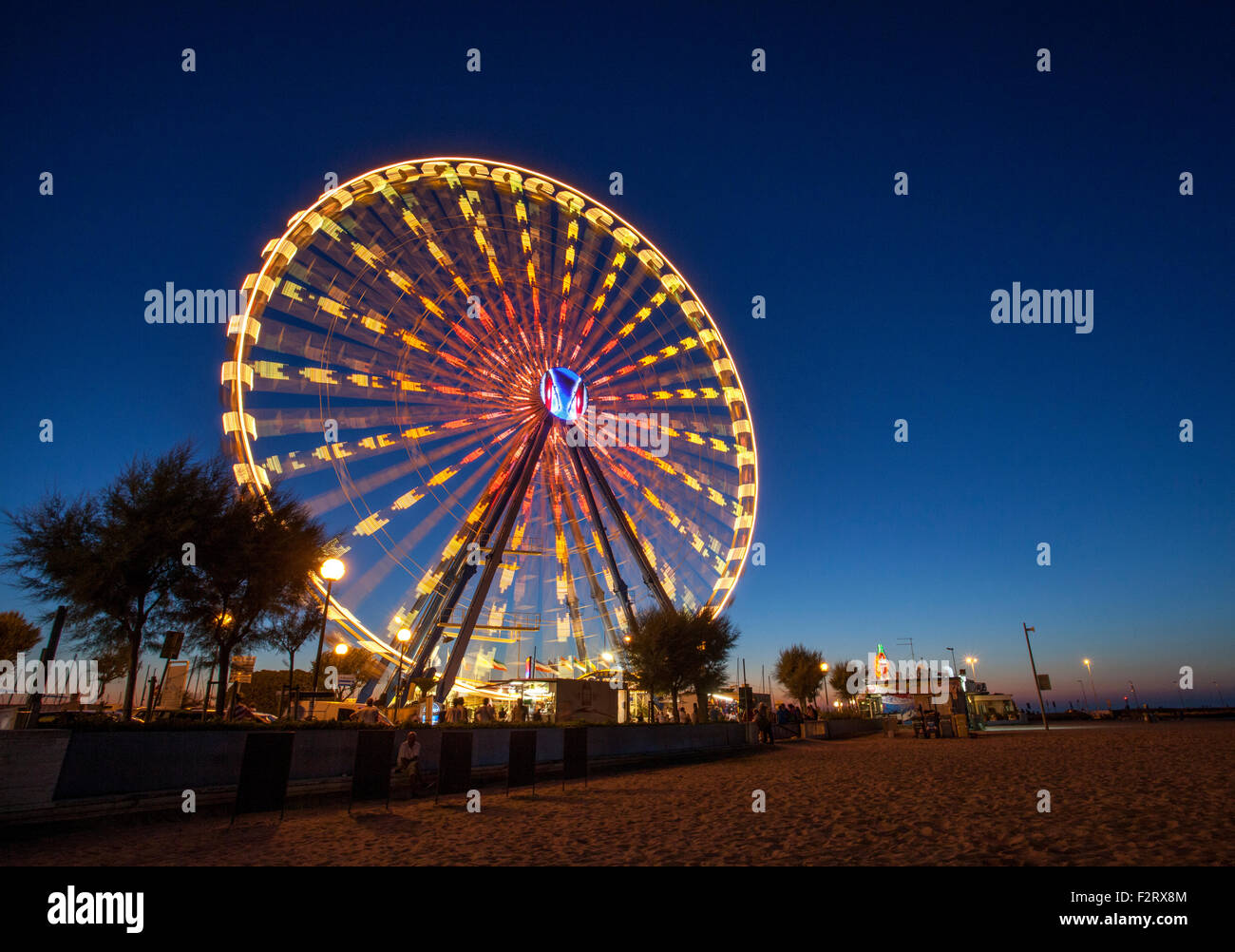 Illuminated Ferris Wheel in blurred motion Stock Photo