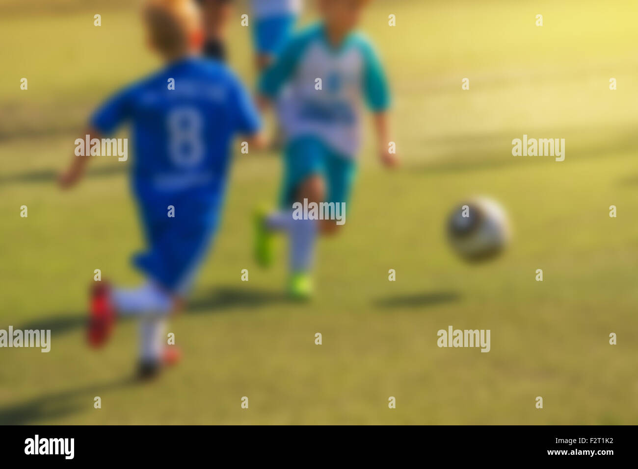 Kids playing soccer, defocussed blur sport background image Stock Photo