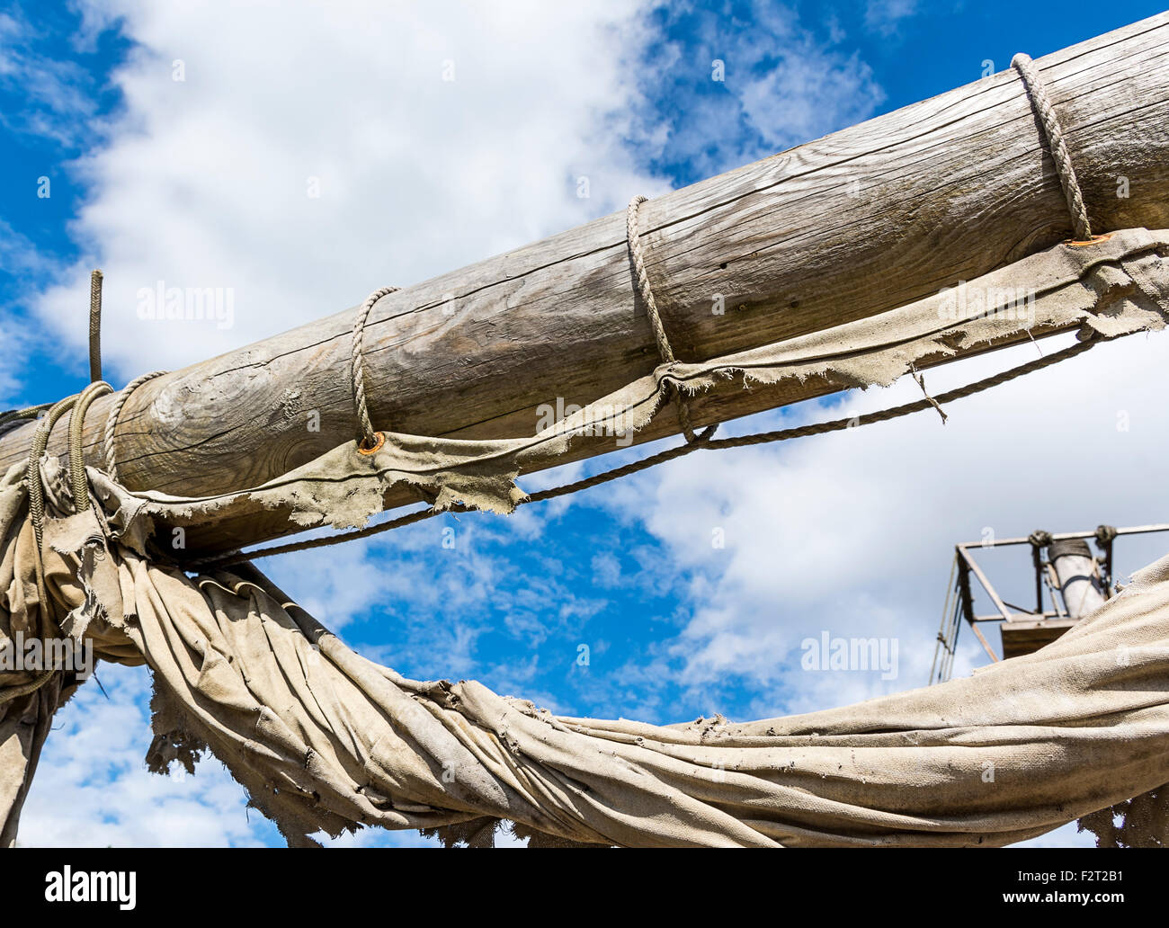 Old ragged sailing rigging an ancient sailing vessel against cloudy sky ...