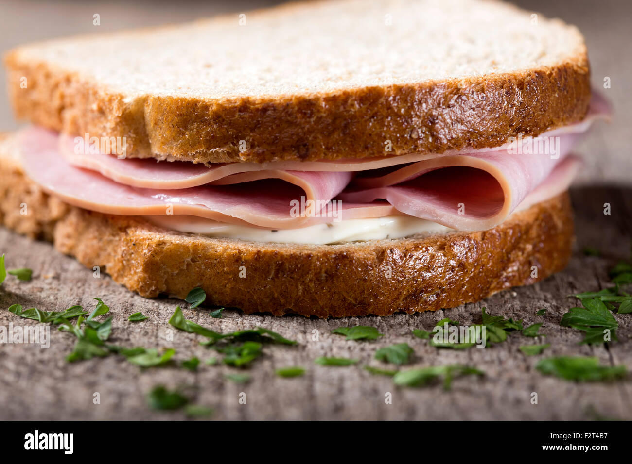 Salami and cream cheese sandwich over wooden background Stock Photo