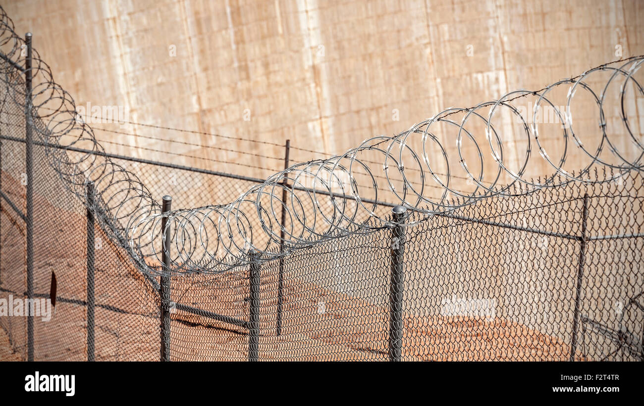 Barbed wire fence, shallow depth of field, crime and punishment concept photo. Stock Photo