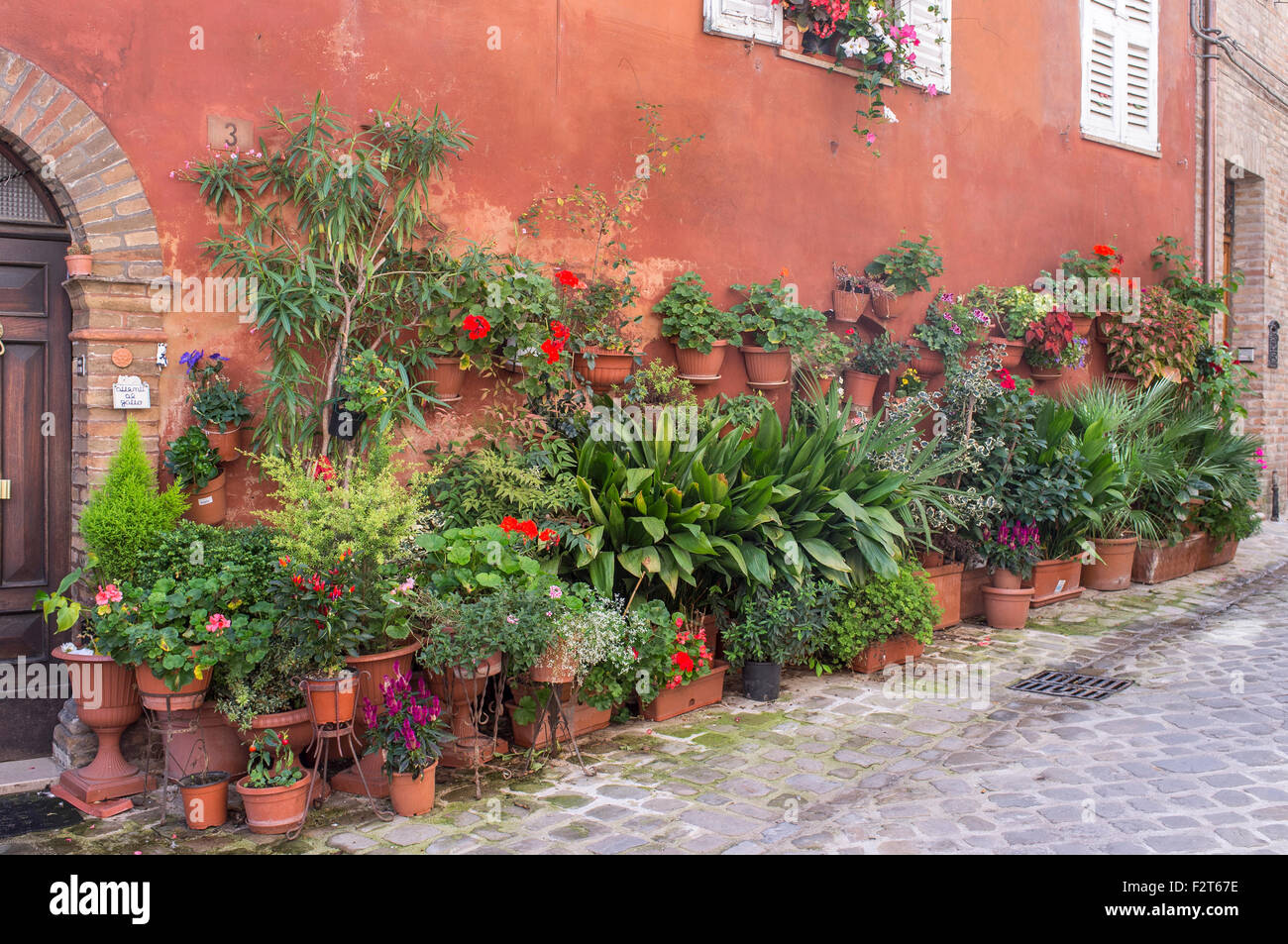 House with Street Garden of Pots and Hanging Baskets in Amandola Italy Stock Photo