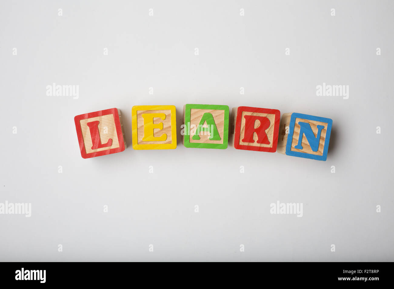 children's word blocks spelling out the word learn Stock Photo