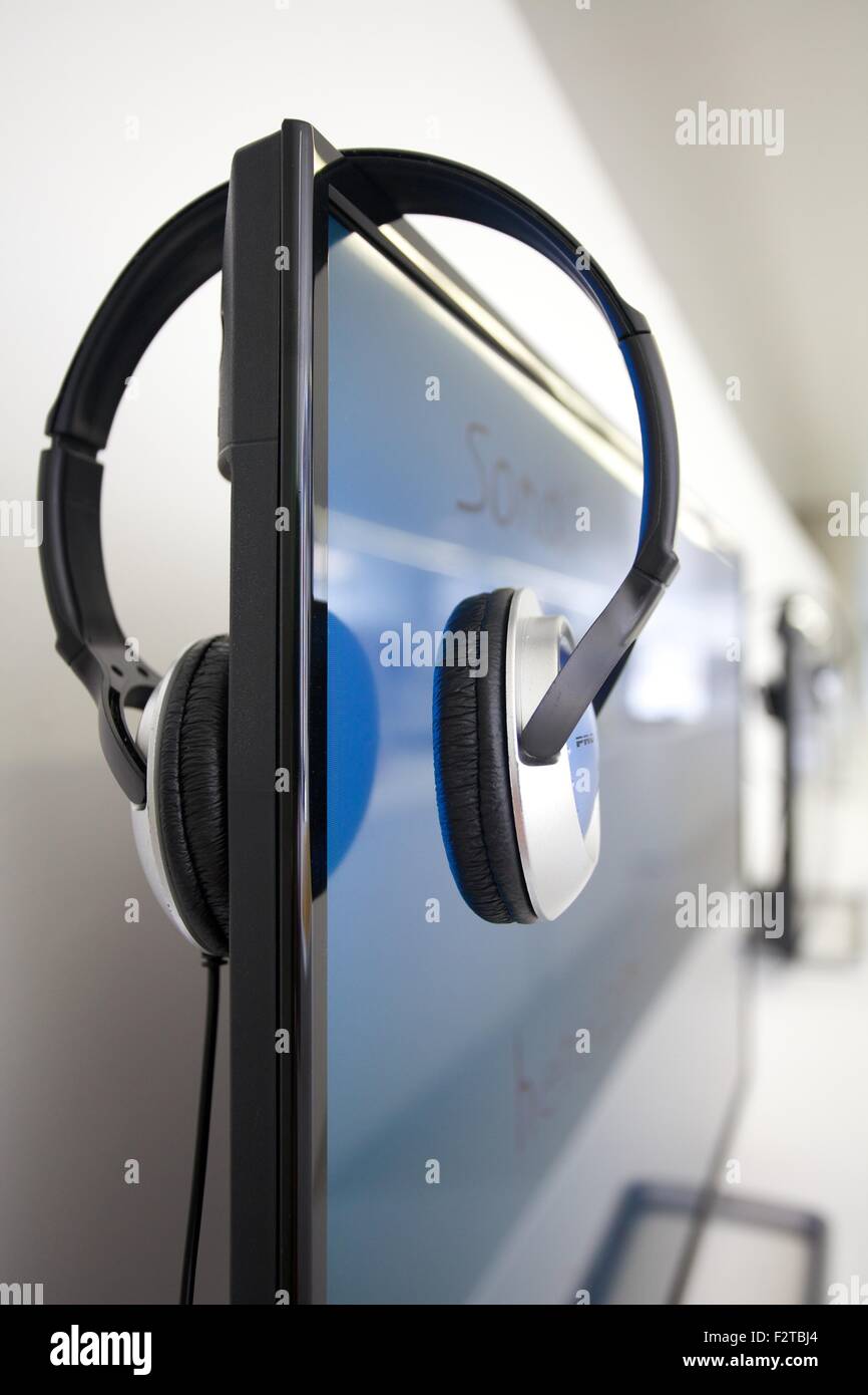 Headphones resting on computer screen hi-res stock photography and ...