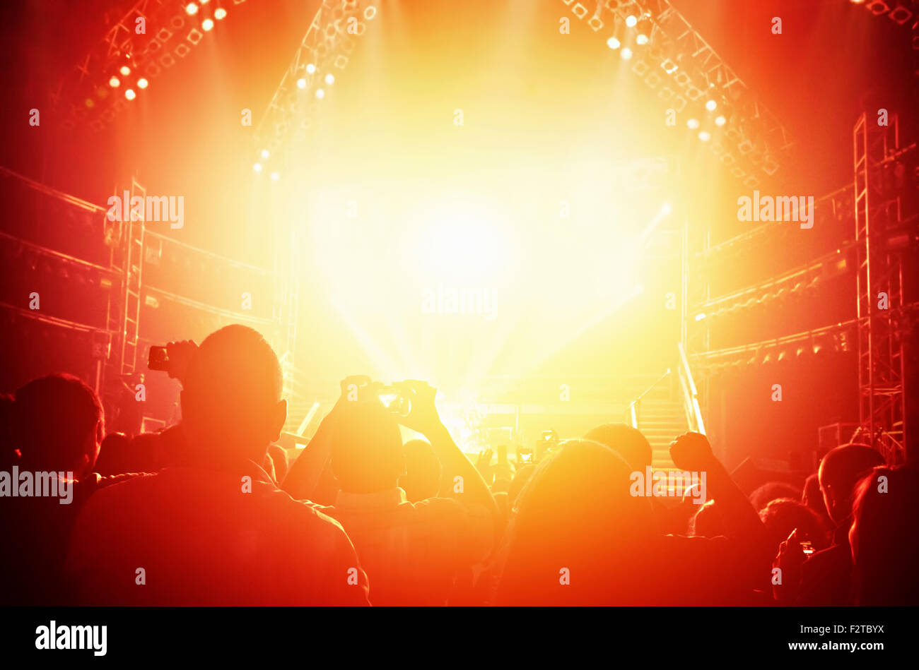 Concert background, many happy young people having fun listening to music,  great night performance in orange bright lights Stock Photo - Alamy