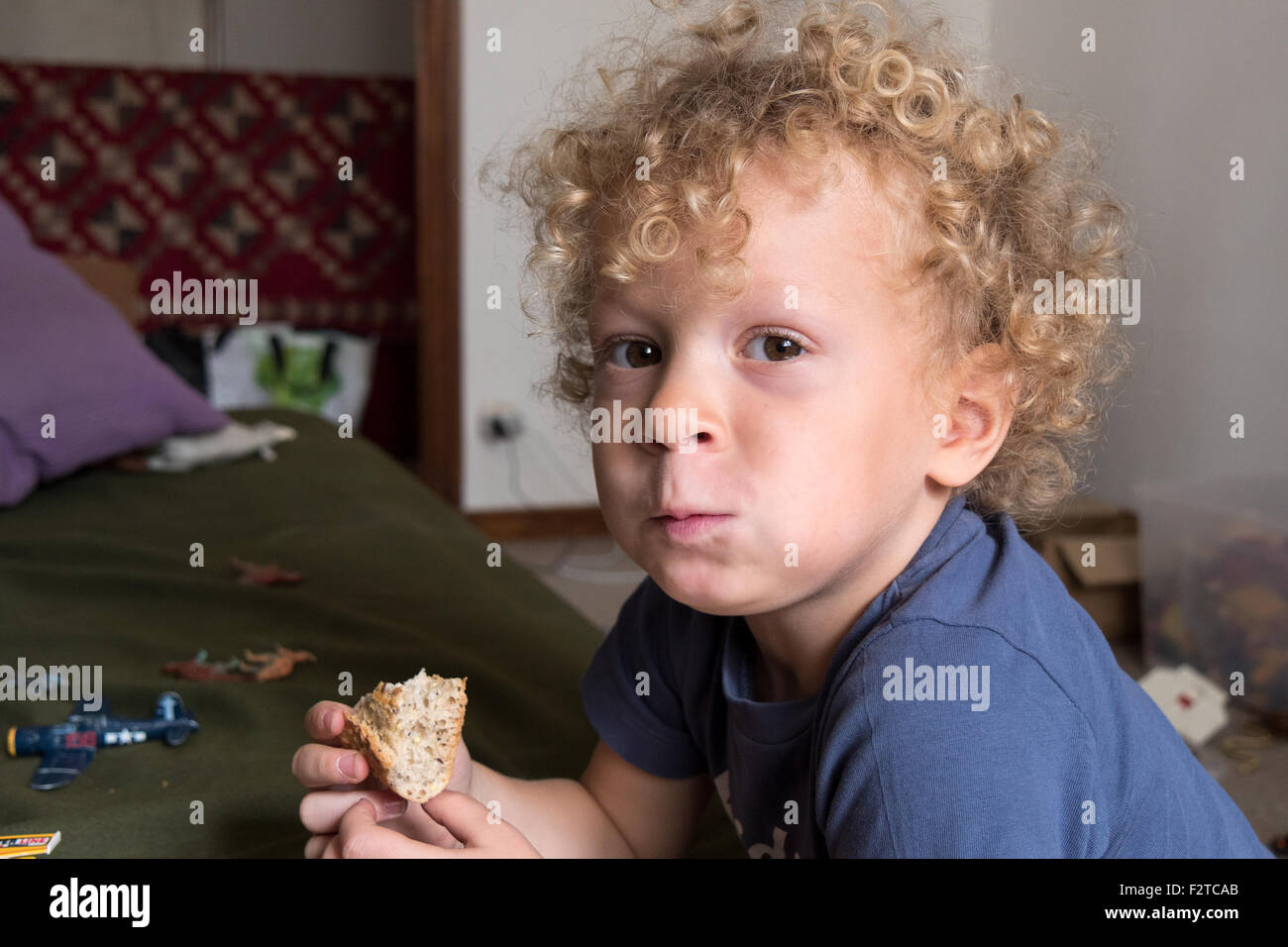 a young child with bread in hand Stock Photo Alamy