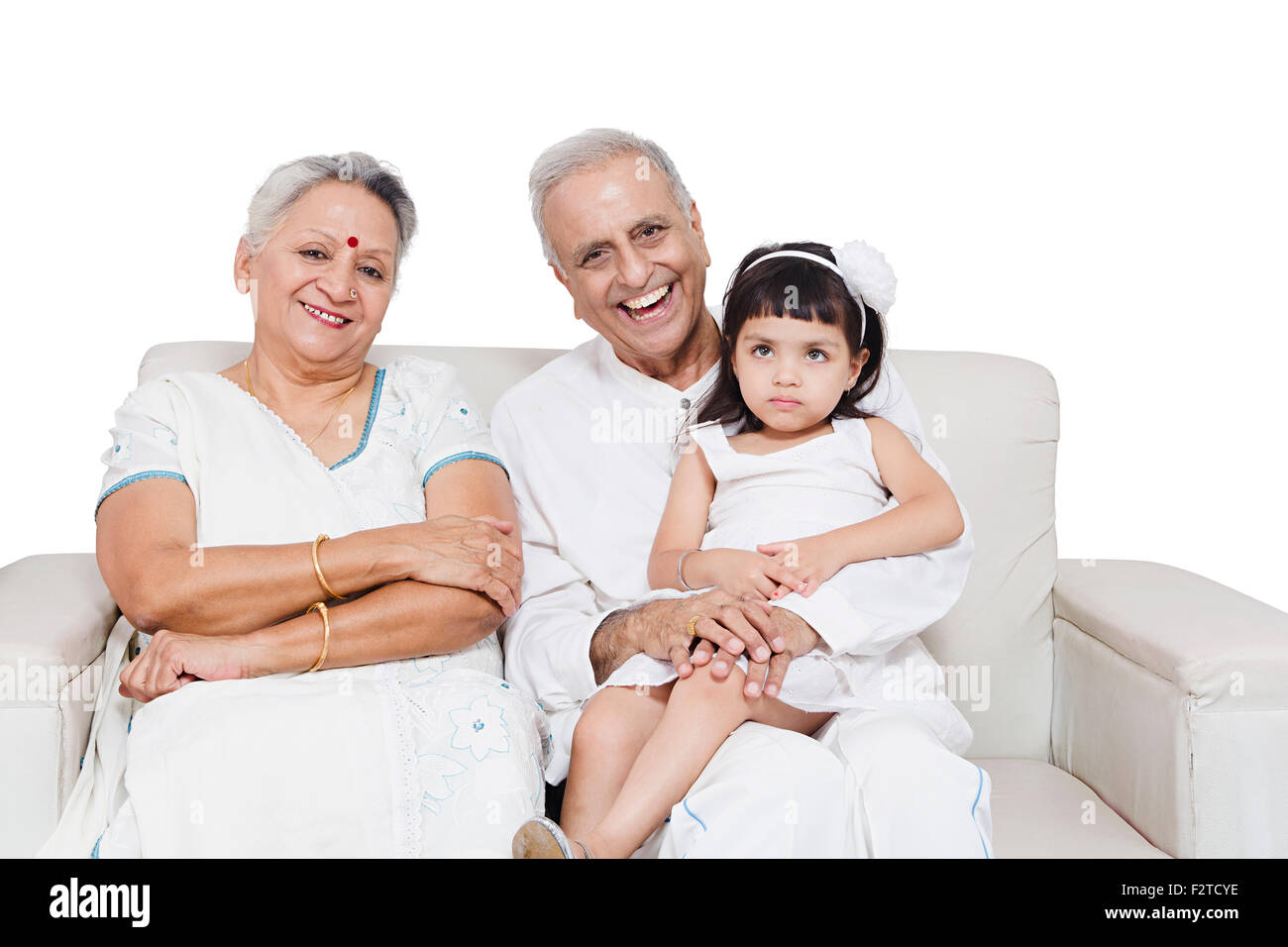 3 indian Grandparents and Granddaughter sitting sofa Stock Photo